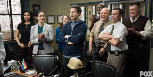 Jake proudly accepts his "gun and badge" after being reinstated to the squad.